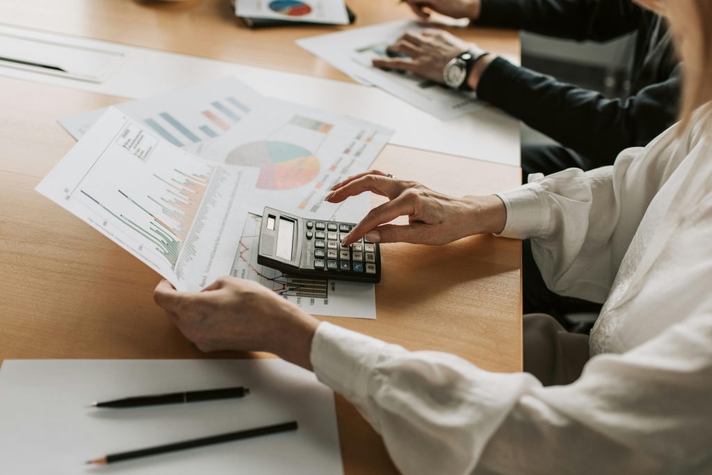 Man calculating pro rate share of his investments while holding papers