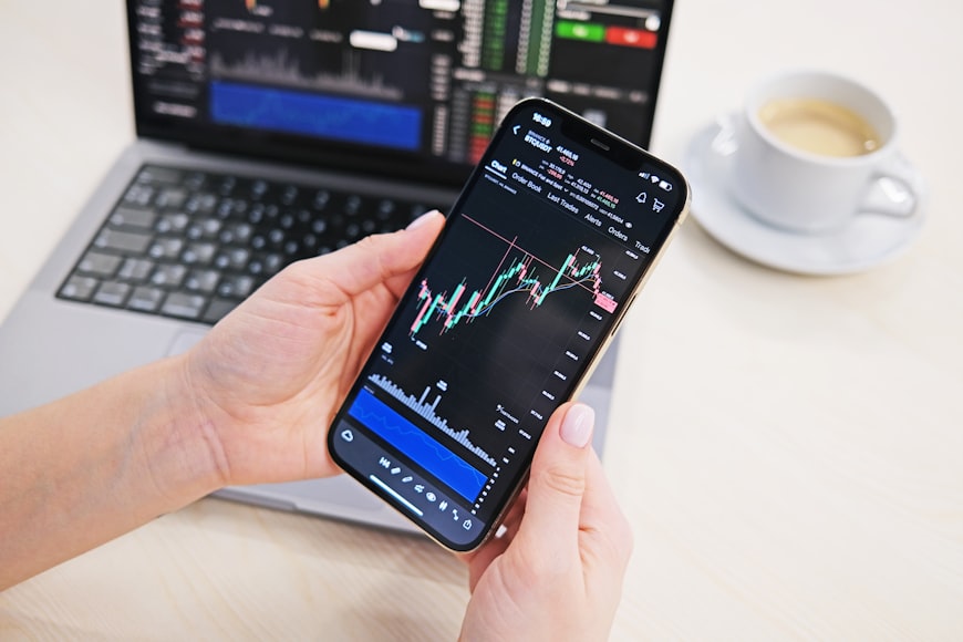 Person monitoring their investments in a three fund portfolio on a smartphone