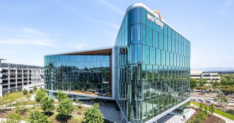 Workday headquarters modern glass office building with landscaped campus under clear sky