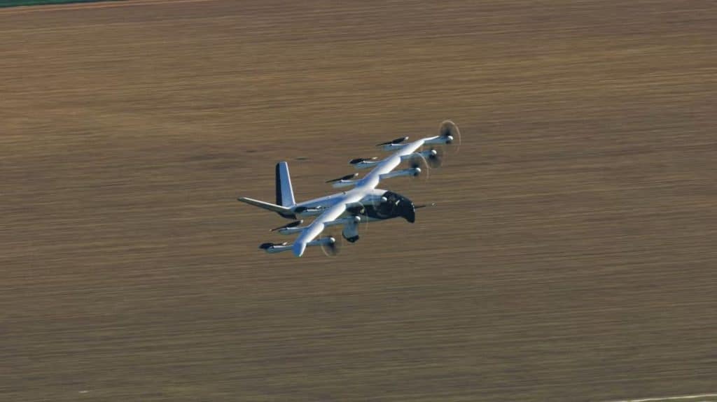 Archer Aviation eVTOL aircraft flying over open farmland during test flight, showcasing electric vertical takeoff and landing technology.