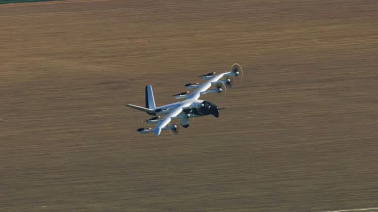 Archer Aviation eVTOL aircraft flying over open farmland during test flight, showcasing electric vertical takeoff and landing technology.