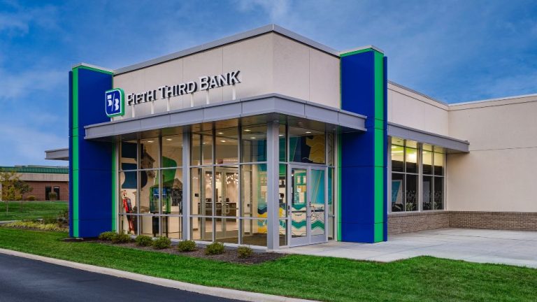Fifth Third Bank branch exterior with modern glass entrance and blue-green branding at dusk