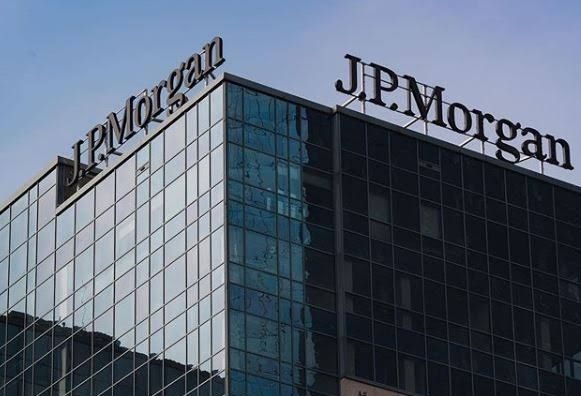 JPMorgan corporate headquarters tower with modern glass architecture and company logo on rooftop.