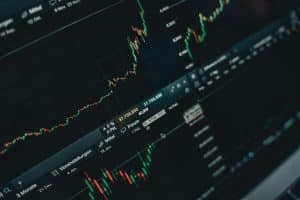 Stock market candlestick chart showing price trends, trading volume, and market corrections on financial dashboard