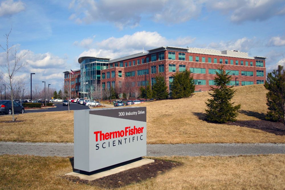 Thermo Fisher Scientific headquarters building at 300 Industry Drive with company sign in front and clear blue sky in the background.