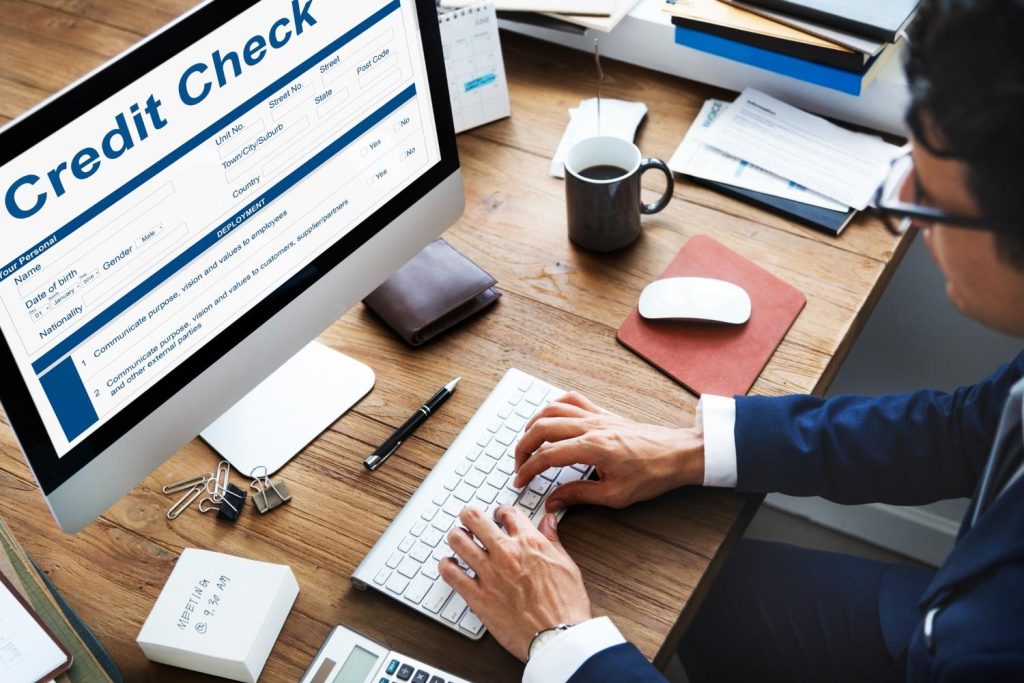 Person checking their credit score through their credit report on a monitor