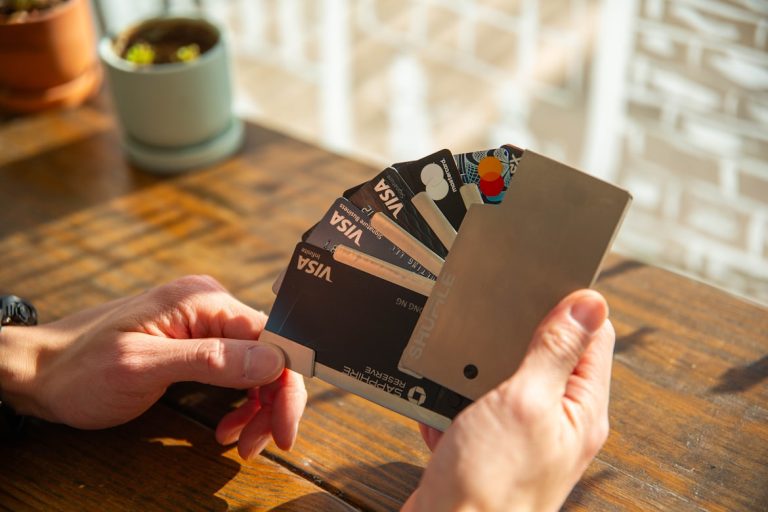 Person holding and choosing best credit cards 2026