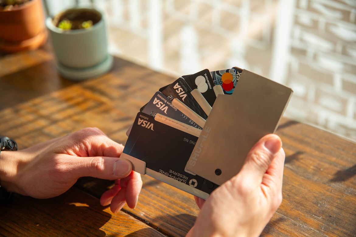 Person holding and choosing best credit cards 2026