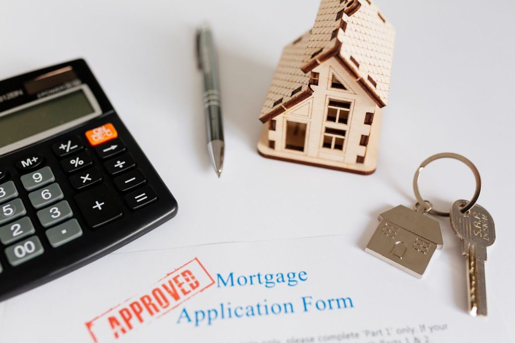 Approved mortgage application form with house model and keys, illustrating VA loans approval process