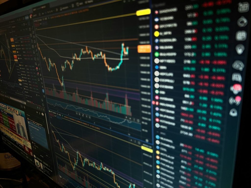 Trading platform displaying market charts, price movements, and chip stocks performance on multiple monitors.