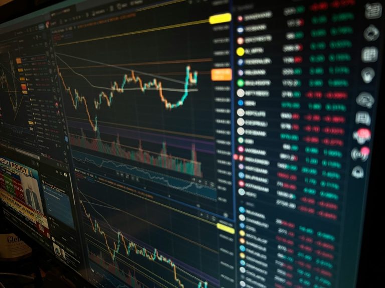Trading platform displaying market charts, price movements, and chip stocks performance on multiple monitors.