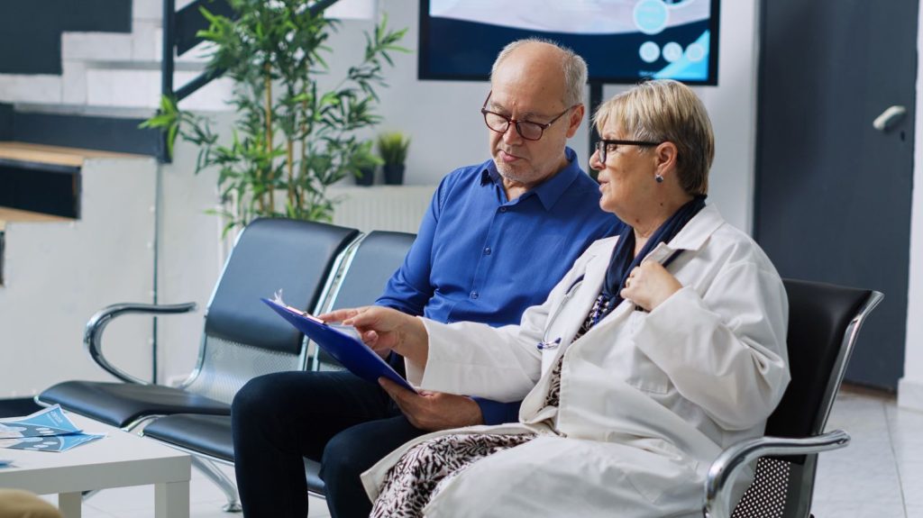Doctor and patient discuss healthcare benefits and enrollment options for Medicaid and Medicare.