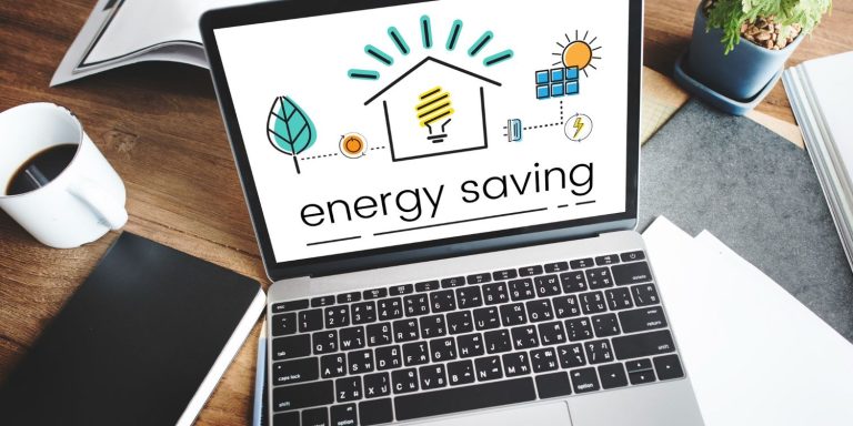 A laptop displaying energy saving tips and eco-friendly icons on how to reduce electricity bill at home.