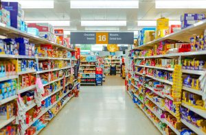 Supermarket snack aisle stocked with packaged goods, illustrating consumer prices and wholesale inflation trends.
