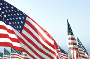 American flags waving outdoors, symbolizing trade and economic trends related to import prices in the United States.
