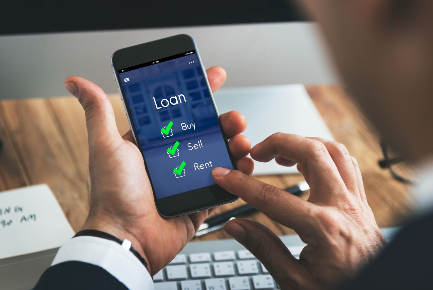 Person using a smartphone to compare loan options, highlighting payday loan alternatives for housing costs.
