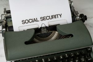 A typewriter prints "Social Security," illustrating Social Security COLA updates and annual benefit adjustments.
