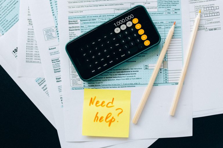 Smartphone calculator on tax forms with a help note for preparing an offer in compromise request.