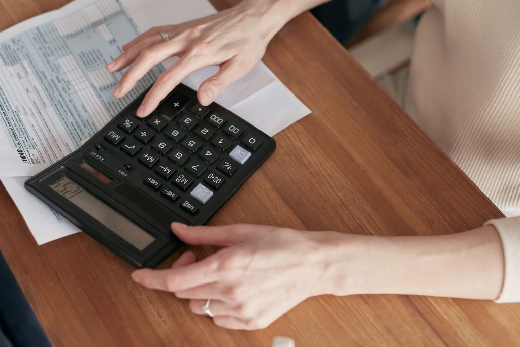 Calculator and tax documents used to estimate payments for an offer in compromise application.